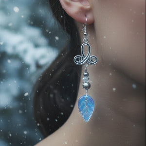 Pair of silver scroll earrings with iridescent leaf-shaped drops