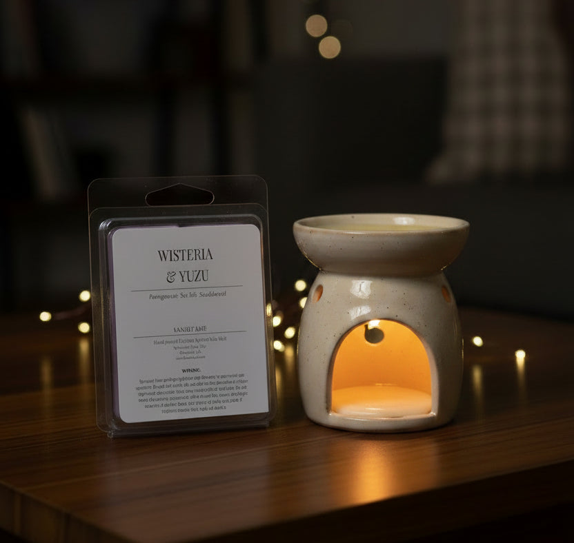Westeria & Yuzu candle packaging on a wooden surface